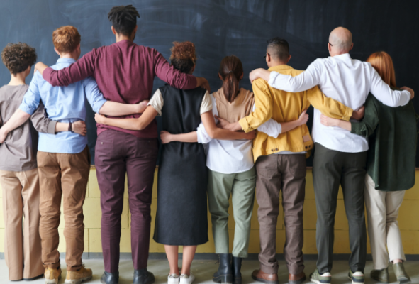 A group of people standing in front of a blackboard