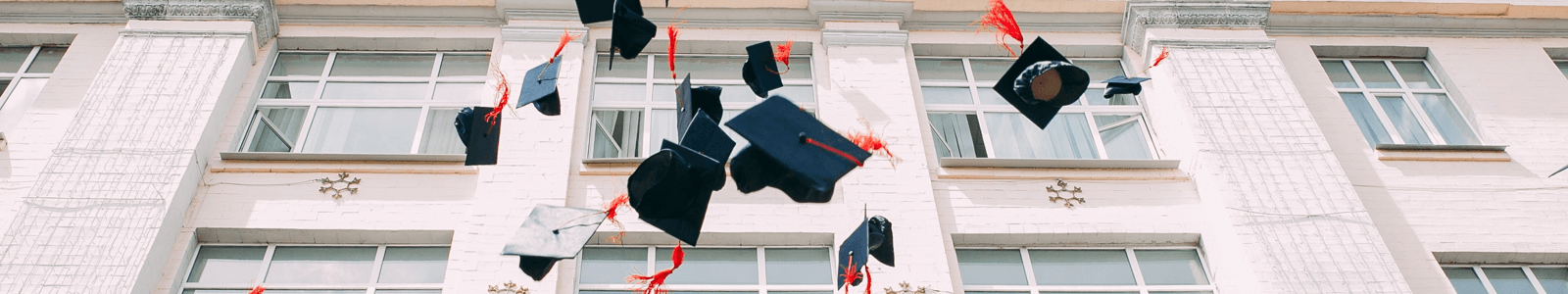 graduation caps being thrown in the air