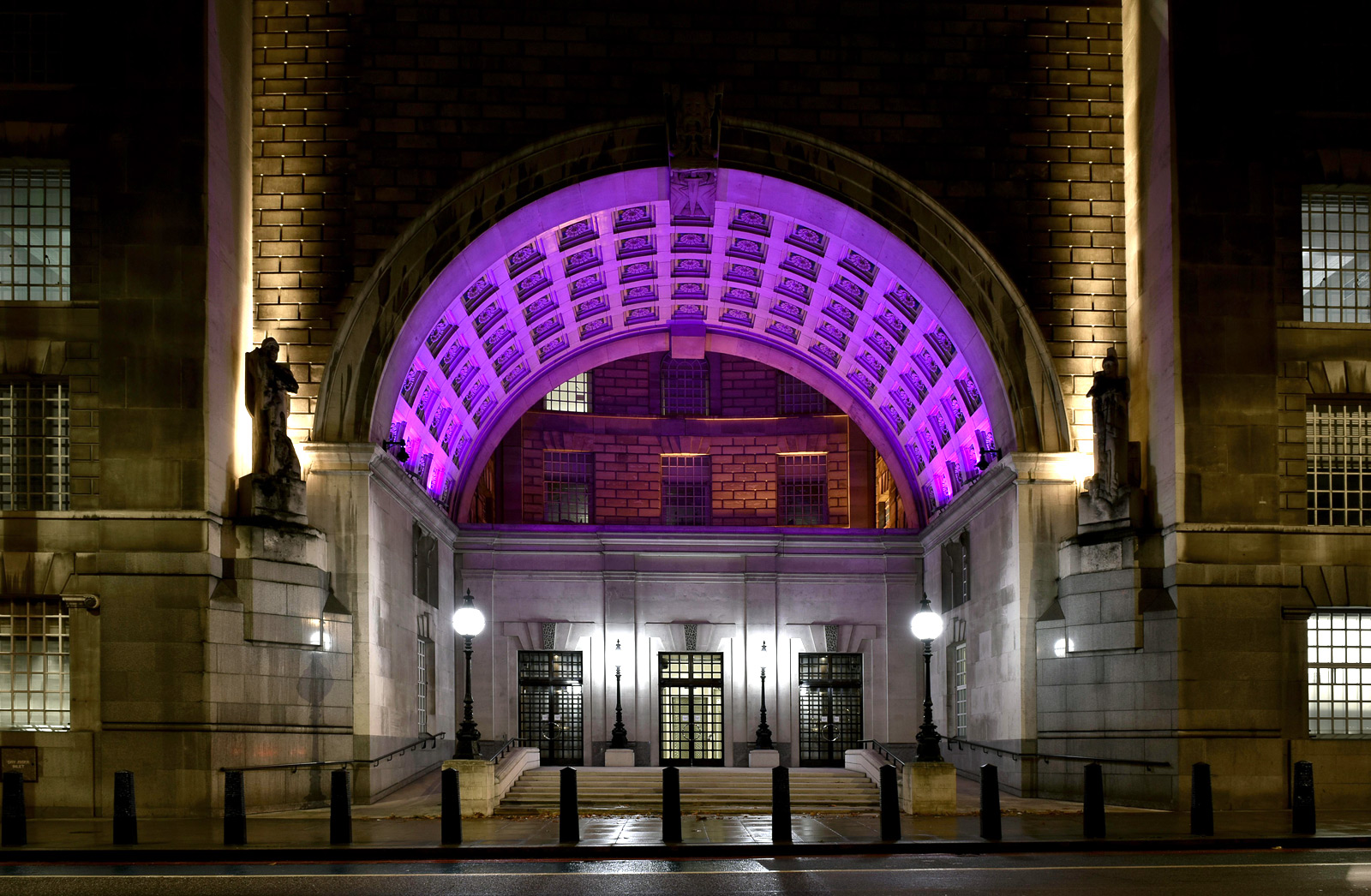 Thames House lit up in purple at night