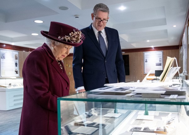 The Queen looking at museum display